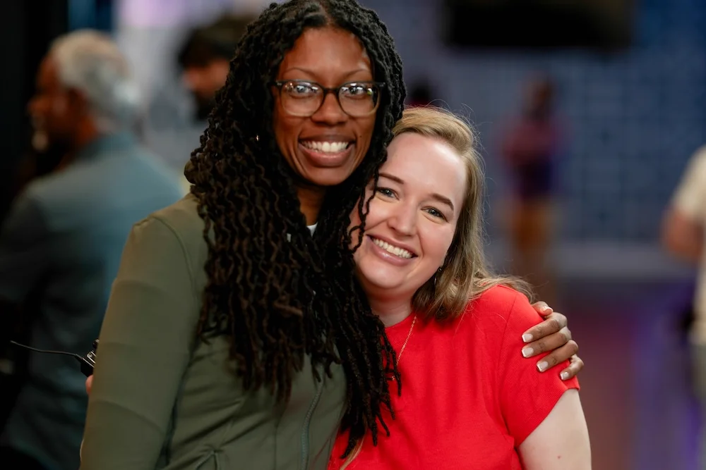 People smiling and connecting at Hue Church